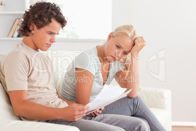 Worried couple reading letters