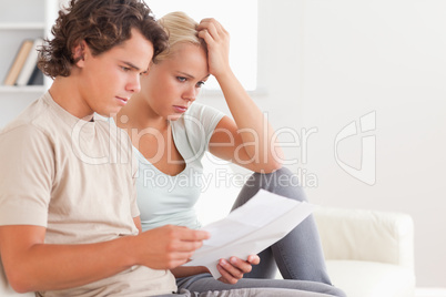 Despaired couple reading letters