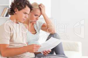 Despaired couple reading letters