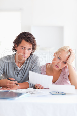 Unhappy couple reading a letter