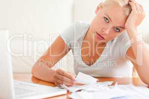Despaired woman accounting looking into the camera