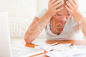 Worried blond woman accounting