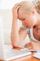 Close up of a Worried blond woman accounting