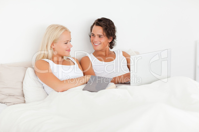 Smiling couple in their bed