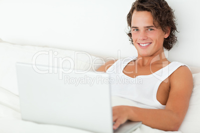 Smiling man using a notebook