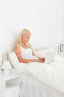 Blond-haired woman using a laptop