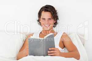 Handsome man holding a book