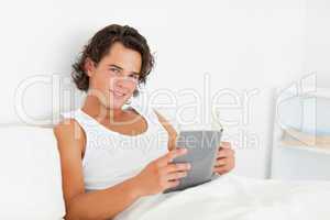 Dark-haired man holding a book