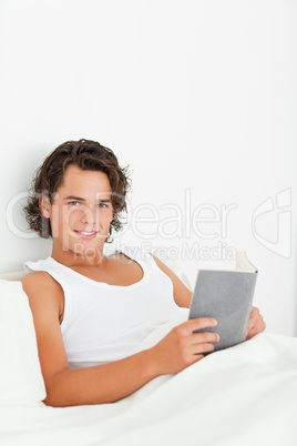 Portrait of a cute man holding a book