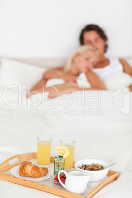 Breakfast on a tray with a couple sleeping