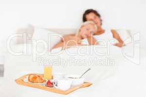 Cute couple with the breakfast put on a tray