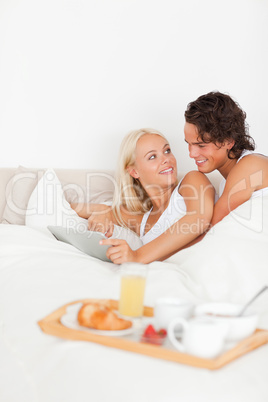 Portrait of a lovely couple using a tablet computer
