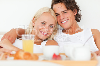 Close up of a smiling couple having breakfast