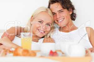 Close up of a smiling couple having breakfast