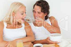 Happy couple eating breakfast