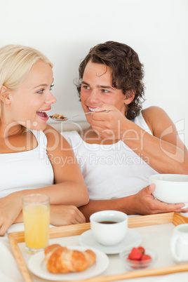 Portrait of a cute couple eating breakfast