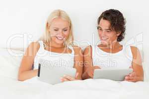 Couple using tablet computers