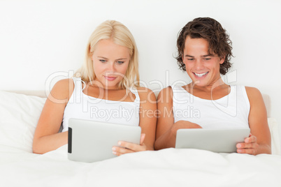 Young couple using tablet computers