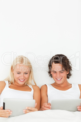 Portrait of a couple young using tablet computers