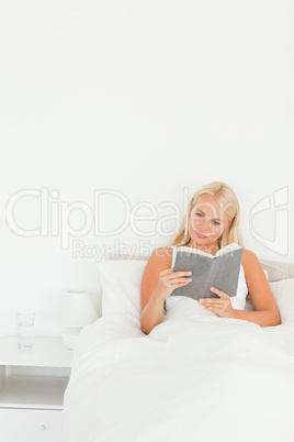 Portrait of a cute woman reading a book