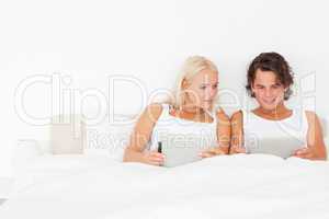 Beautiful couple using tablet computers