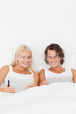 Portrait of a couple with tablet computers