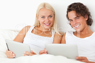 Young couple with tablet computers