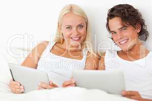 Young couple with tablet computers
