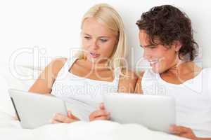 Lovely couple using tablet computers
