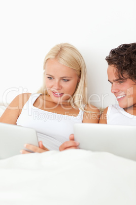 Portrait of a lovely couple using tablet computers