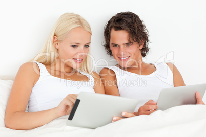 Gorgeous couple using tablet computers