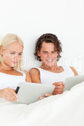 Portrait of a gorgeous couple using tablet computers