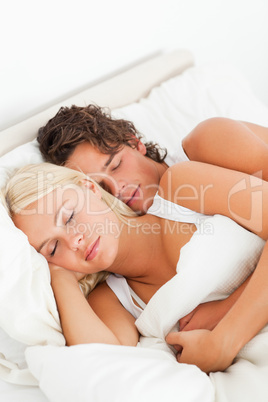 Couple hugging while sleeping