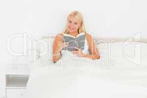 Smiling woman holding a book
