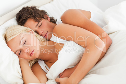 Quiet couple hugging while sleeping
