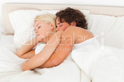 Calm couple hugging while sleeping