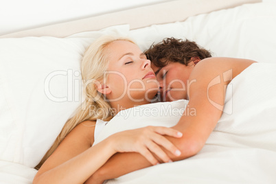 Lovely couple hugging while sleeping