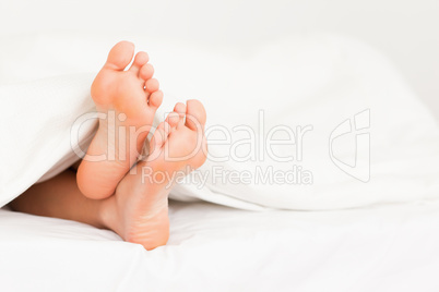 Feet in a bed