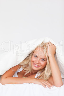 Portrait of a woman under a duvet