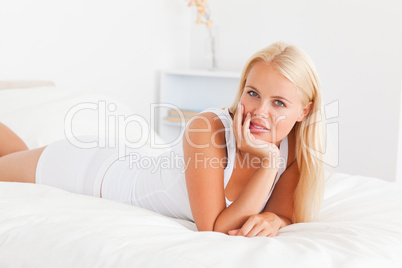 Woman posing on her bed