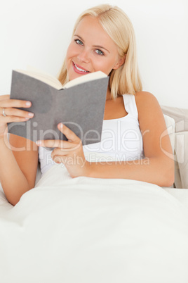 Portrait of a smiling woman holding a book