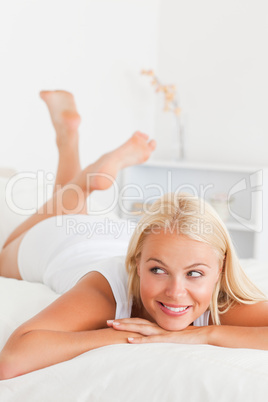 Portrait of a gorgeous woman lying on her bed