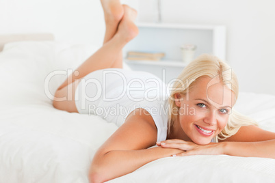 Cute woman lying on her bed