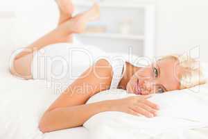 Lovely woman lying on her bed