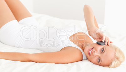 Woman lying on her back on the phone