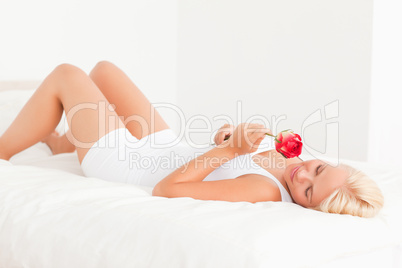 Serene woman smelling a flower