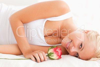 Close up of a smiling woman with a rose