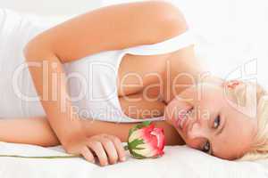 Close up of a smiling woman with a rose