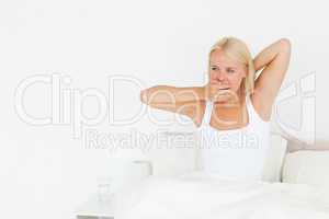 Woman yawning on her bed