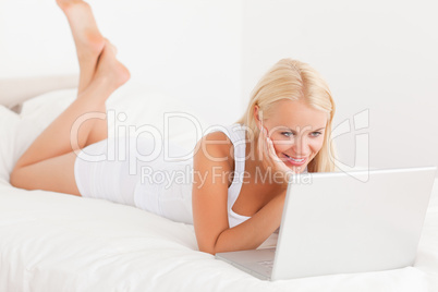 Smiling woman using a laptop Smiling woman using a laptop